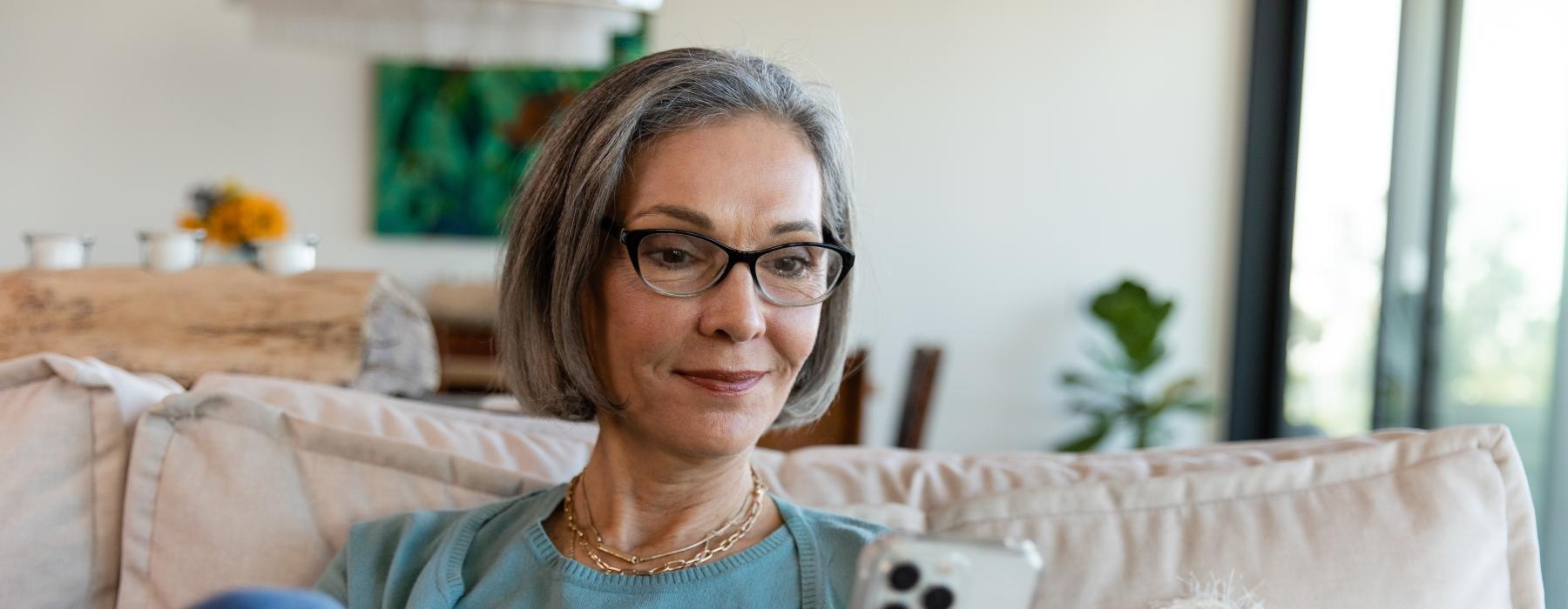 a woman looking at her smart device